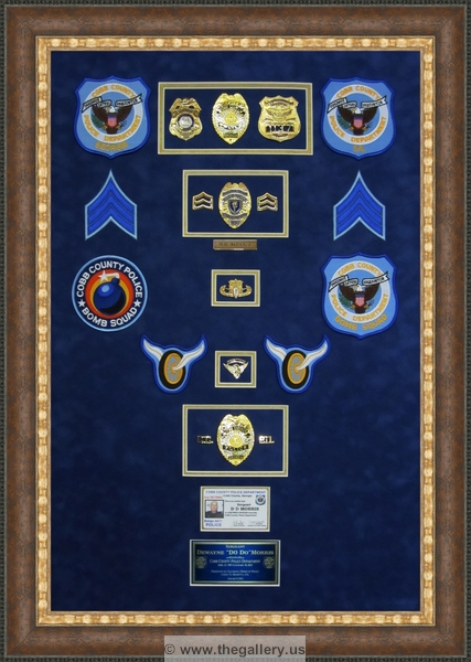 Cobb County Police Department retirement shadow box with police badges, patches, ID cards and lapel pins.






The Gallery at Brookwood
www.thegallery.us
770-941-3394
Your Custom Framing Expert
Picture Framing Examples
Custom Framing Examples
Shadowbox Examples
Cobb_Police_Department_retirement_shadow_box_with_badges