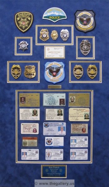 Cobb County Police Department retirement shadow box with police badges, patches, ID cards and lapel pins.






The Gallery at Brookwood
www.thegallery.us
770-941-3394
Your Custom Framing Expert
Picture Framing Examples
Custom Framing Examples
Shadowbox Examples
IMG_2404
