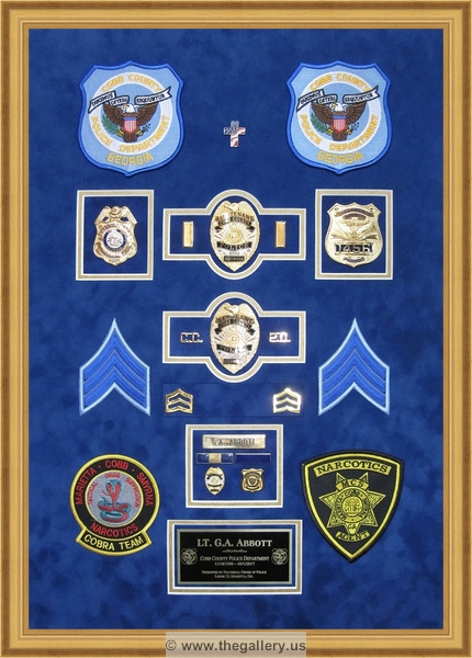 Cobb County Police Department retirement shadow box with police badges, patches, ID cards and lapel pins.


Police Department retirement shadow box examples



The Gallery at Brookwood
www.thegallery.us
770-941-3394
Your Custom Framing Expert
Picture Framing Examples
Custom Framing Examples
Shadowbox Examples
cobb-county-police-department-shadowbox