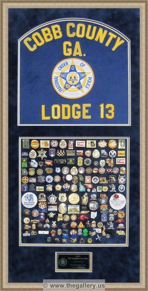 Cobb County Police Department retirement shadow box with police badges, patches, ID cards and lapel pins.






The Gallery at Brookwood
www.thegallery.us
770-941-3394
Your Custom Framing Expert
Picture Framing Examples
Custom Framing Examples
Shadowbox Examples
custom_police_shadow_box