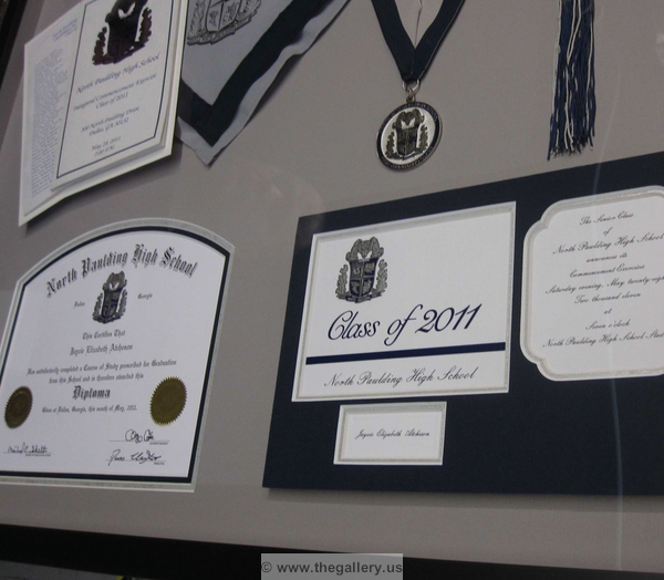 Detail view of Paulding County Georgia High School Graduation Shadow box with hat, tassel, high school diploma and graduation announcement.






The Gallery at Brookwood
www.thegallery.us
770-941-3394
Your Custom Framing Expert
Picture Framing Examples
Custom Framing Examples
Shadowbox Examples
paulding_county_grad detail