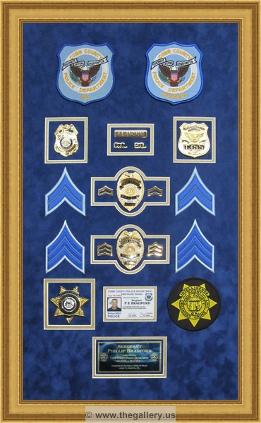 Cobb County Police Department retirement shadow box with police badges, patches, ID cards and lapel pins.


Police Department retirement shadow box examples



The Gallery at Brookwood
www.thegallery.us
770-941-3394
Your Custom Framing Expert
Picture Framing Examples
Custom Framing Examples
Shadowbox Examples
police_department_shadow_box