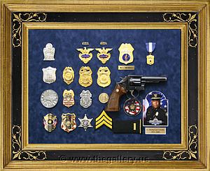Police retirement shadow box with gun, badges, patchs, photo, lapel pins and awards.

The Gallery at Brookwood
www.thegallery.us
770-941-3394
Your Custom Framing Expert
Picture Framing Examples
Custom Framing Examples
Shadowbox Examples