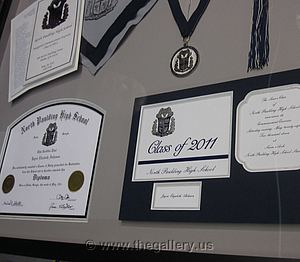 Detail view of Paulding County Georgia High School Graduation Shadow box with hat, tassel, high school diploma and graduation announcement.

The Gallery at Brookwood
www.thegallery.us
770-941-3394
Your Custom Framing Expert
Picture Framing Examples
Custom Framing Examples
Shadowbox Examples