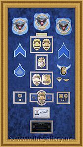  Police Department retirement shadow box with police badges, patches, ID cards and lapel pins.

The Gallery at Brookwood
www.thegallery.us
770-941-3394
Your Custom Framing Expert
Picture Framing Examples
Custom Framing Examples
Shadowbox Examples