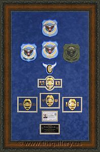 Cobb County Police Department retirement shadow box with police badges, patches, ID cards and lapel pins.

The Gallery at Brookwood
www.thegallery.us
770-941-3394
Your Custom Framing Expert
Picture Framing Examples
Custom Framing Examples
Shadowbox Examples