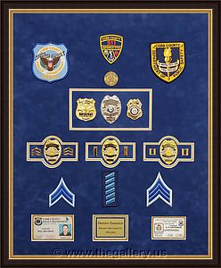  Police Department retirement shadowbox with police badges, patches, ID cards and lapel pins.

The Gallery at Brookwood
www.thegallery.us
770-941-3394
Your Custom Framing Expert
Picture Framing Examples
Custom Framing Examples
Shadowbox Examples